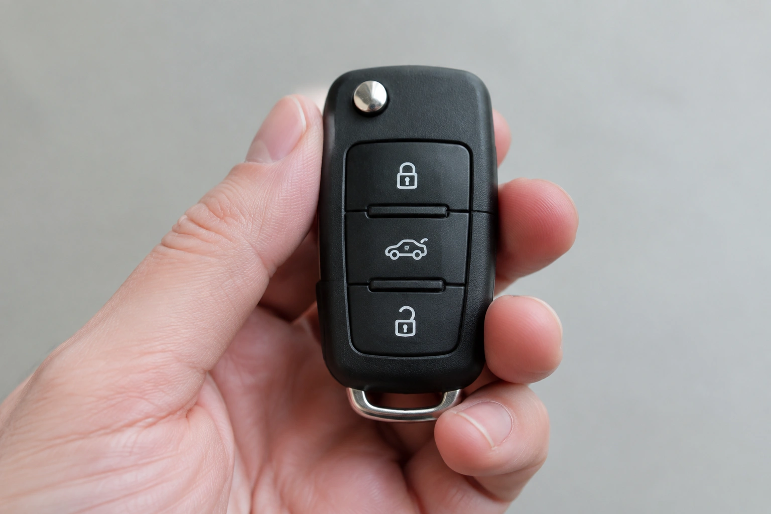 Car key fob held in hand for troubleshooting